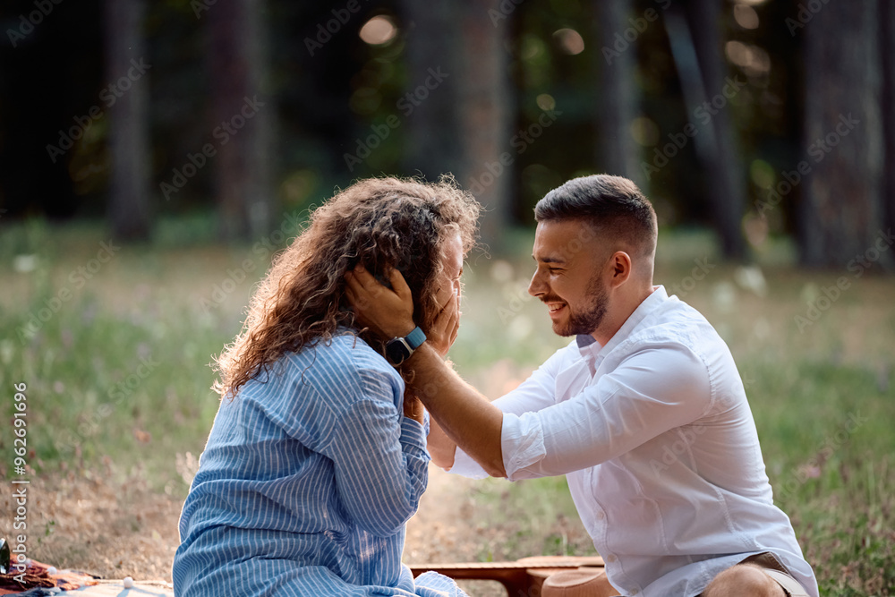 Young woman feeling touched while her boyfriend declares his love for her in park. Young woman feeling touched while her boyfriend declares his love for her in park.