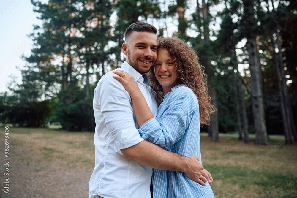 Portrait of happy engaged couple in nature looking at camera. Portrait of happy engaged couple in nature looking at camera.