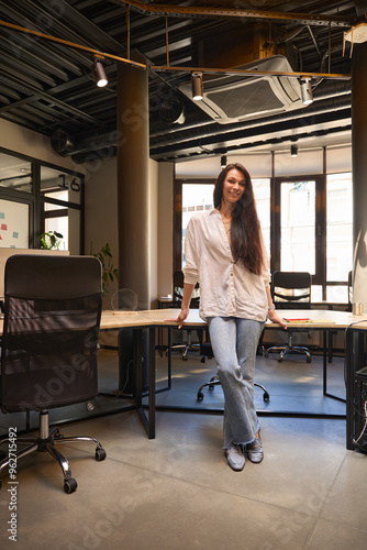 Female in democratic casual clothes in a coworking space