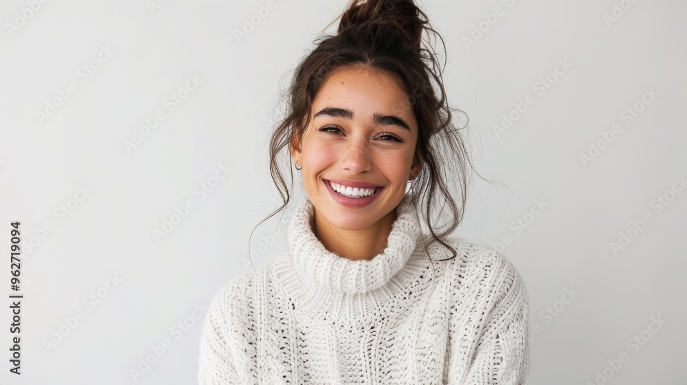 A woman with a white sweater and a ponytail is smiling A woman with a white sweater and a ponytail is smiling