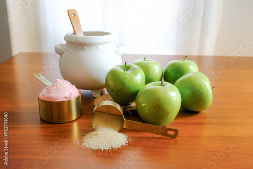 White Cauldron with Green Apples and Gold Measuring Cups