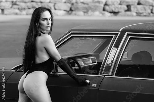 Fotografija Sexy woman posing near luxury american retro car