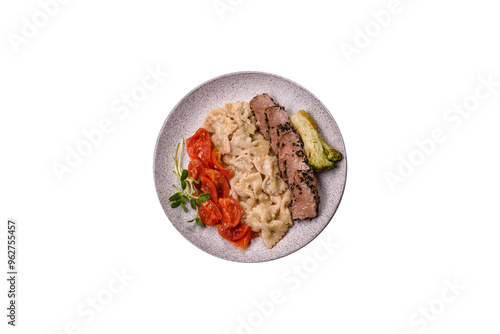 Bowl with slices of baked tuna with broccoli, tomatoes and fusili pasta