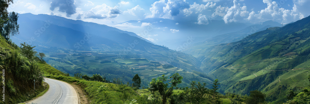 Fototapeta premium Mountain road landscape with winding path, green trees, cloudy mountains. Perfect travel agency and tour image. Scenic view from bicycle point of view. Realistic photo.