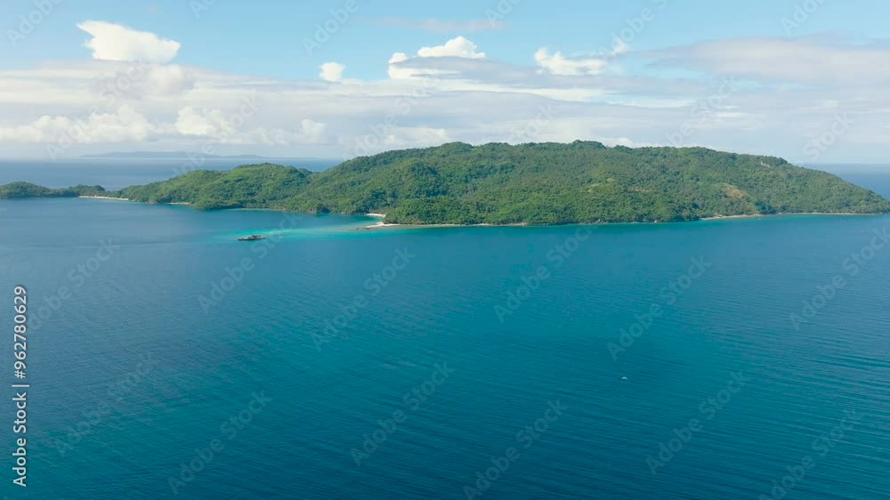 Aerial view of Alad Island surrounded by blue sea. Blue sky and clouds. Romblon, Philippines. Aerial view of Alad Island surrounded by blue sea. Blue sky and clouds. Romblon, Philippines.