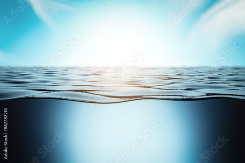 Schilderij op canvas Sunlit water surface with underwater view in blue sky background