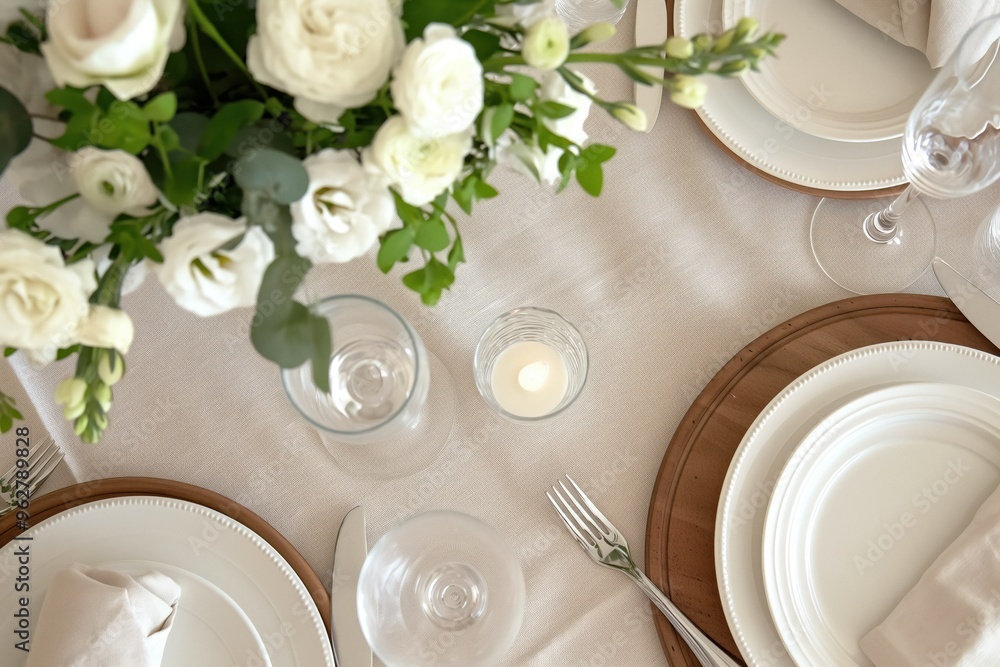Serene dining scene on white tablecloth with vase of white roses, candle, wine glass. Meticulously arranged plates, silverware, napkin create elegant atmosphere. Perfect for fine dining Serene dining scene on white tablecloth with vase of white roses, candle, wine glass. Meticulously arranged plates, silverware, napkin create elegant atmosphere. Perfect for fine dining