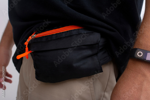 Fényképezés Closeup of a small black fanny pack or belt bag attached to a man's waist