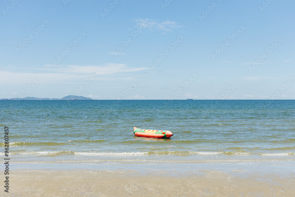 Beach sea space area. Beautiful tropical beach and Inflatable boat with blue sky and white clouds in sunny day Beach sea space area. Beautiful tropical beach and Inflatable boat with blue sky and white clouds in sunny day