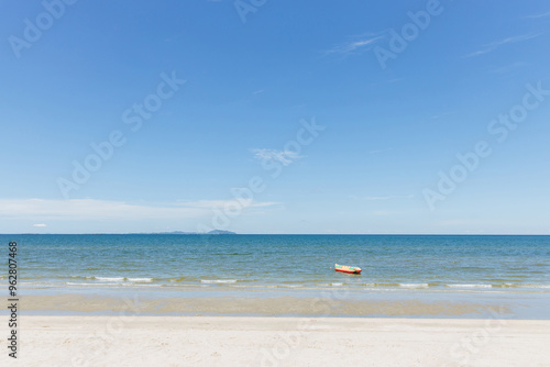 Beach sea space area. Beautiful tropical beach and Inflatable boat with blue sky and white clouds in sunny day photo