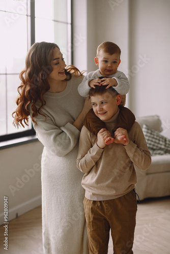 Loving pregnant woman with her older sons. Expecting a baby in the family concept. Preparing an older children for a younger one