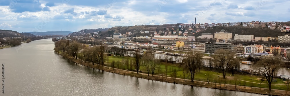 Panoramic view of Prague cityscape along the Vltava River, perfect for illustrating European travel and holiday destinations Panoramic view of Prague cityscape along the Vltava River, perfect for illustrating European travel and holiday destinations