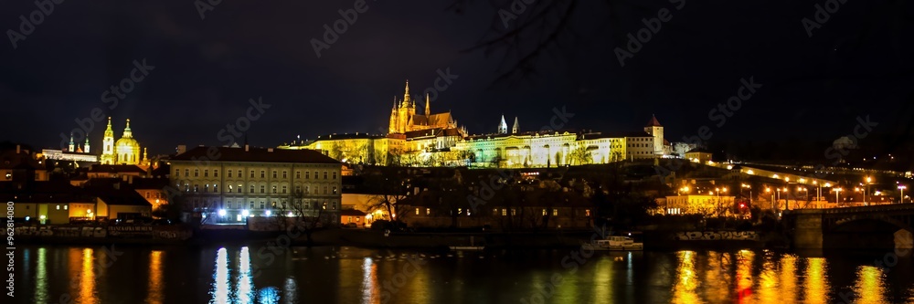 Fototapeta premium Night view of Prague Castle and Charles Bridge illuminated during the Christmas season in Prague, Czech Republic