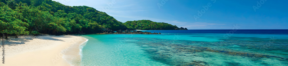 A sweeping view of a tropical coastline with crystal-clear waters gently lapping at a pristine white sandy beach, surrounded by lush greenery under a cloudless sky A sweeping view of a tropical coastline with crystal-clear waters gently lapping at a pristine white sandy beach, surrounded by lush greenery under a cloudless sky