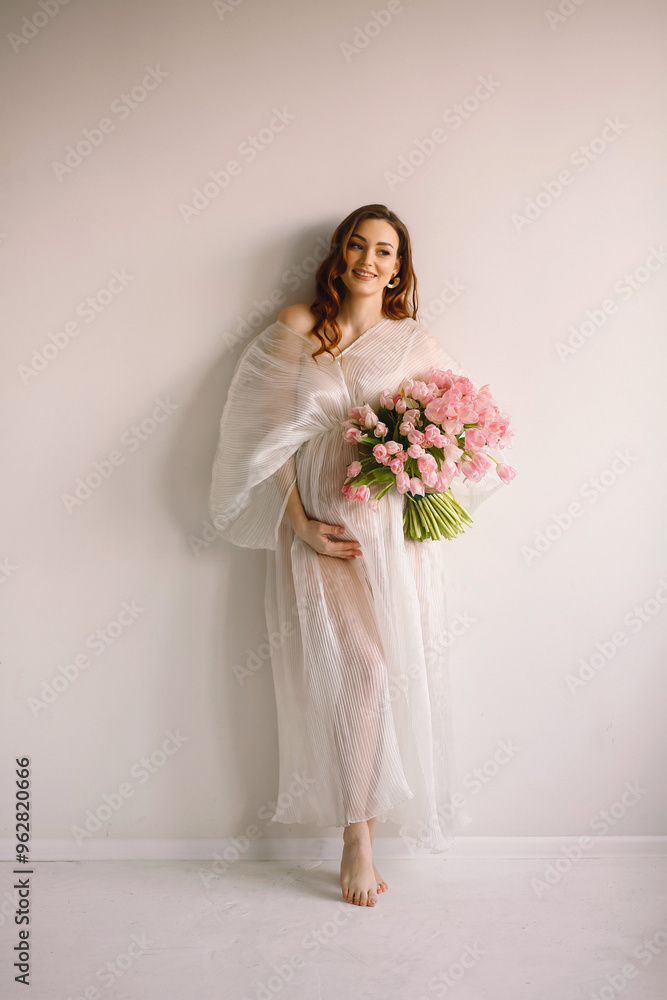 Portrait of pregnant woman in white dress with bouquet of tulips Portrait of pregnant woman in white dress with bouquet of tulips