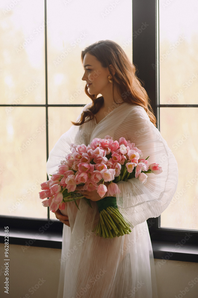 Portrait of pregnant woman in white dress with bouquet of tulips Portrait of pregnant woman in white dress with bouquet of tulips