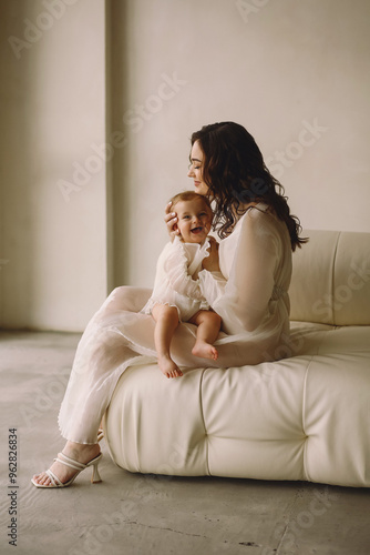 Mother and her baby girl together. Love. Happy Mother and Baby hugging. Family look. Maternity concept