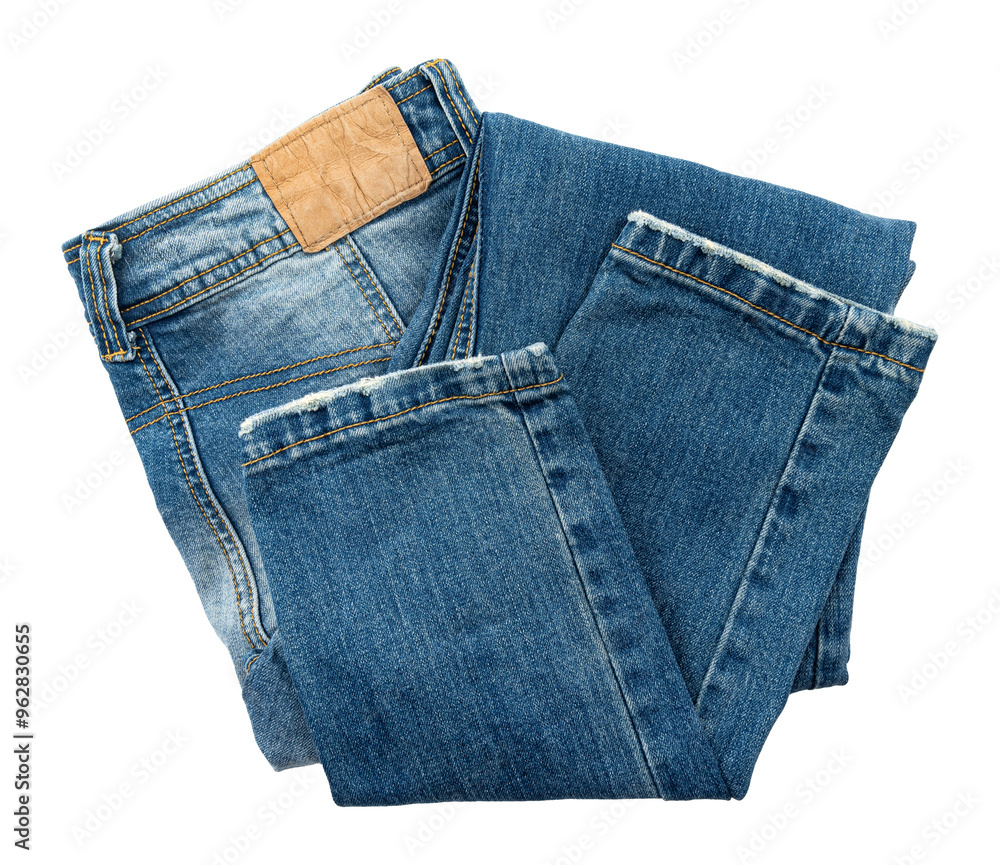 Folded dark blue jeans on a white background. Cloth. Jeans isolate Folded dark blue jeans on a white background. Cloth. Jeans isolate