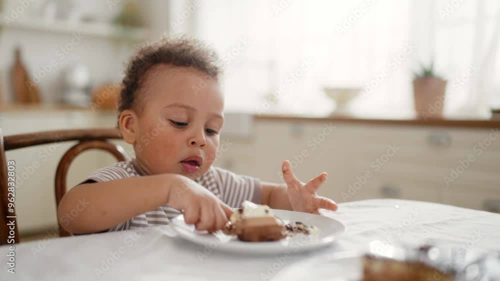 Family dinner, portrait of cute African toddler eating sweet cake with chocolate . Carefree childhood, infancy, enjoy delicious dessert, charming black little boy or girl licking fingers, funny face Family dinner, portrait of cute African toddler eating sweet cake with chocolate . Carefree childhood, infancy, enjoy delicious dessert, charming black little boy or girl licking fingers, funny face