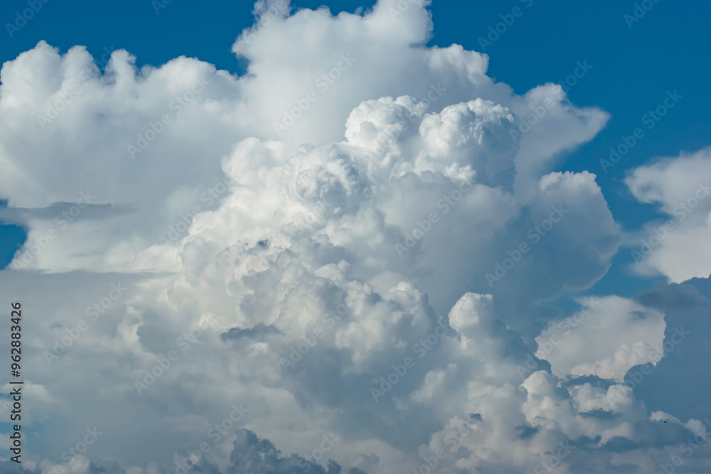 Beautiful white anime-looking clouds over a blue sky for the background.