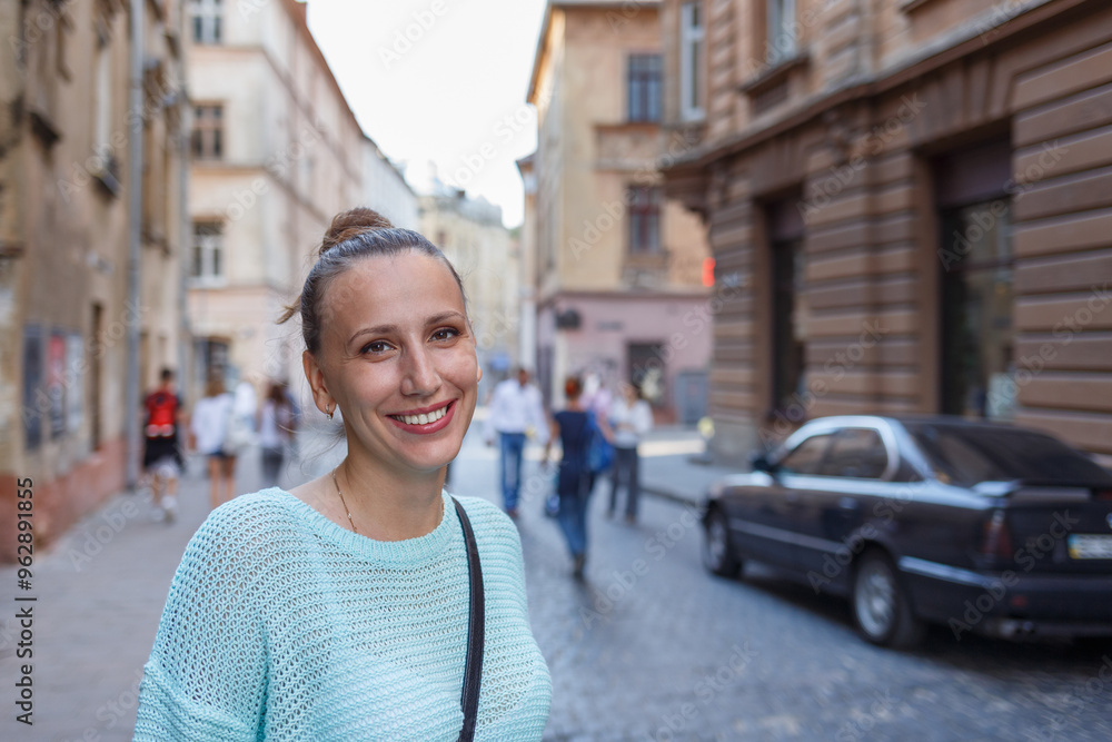 Smiling woman enjoying a sunny day in a charming European street with historical architecture Smiling woman enjoying a sunny day in a charming European street with historical architecture