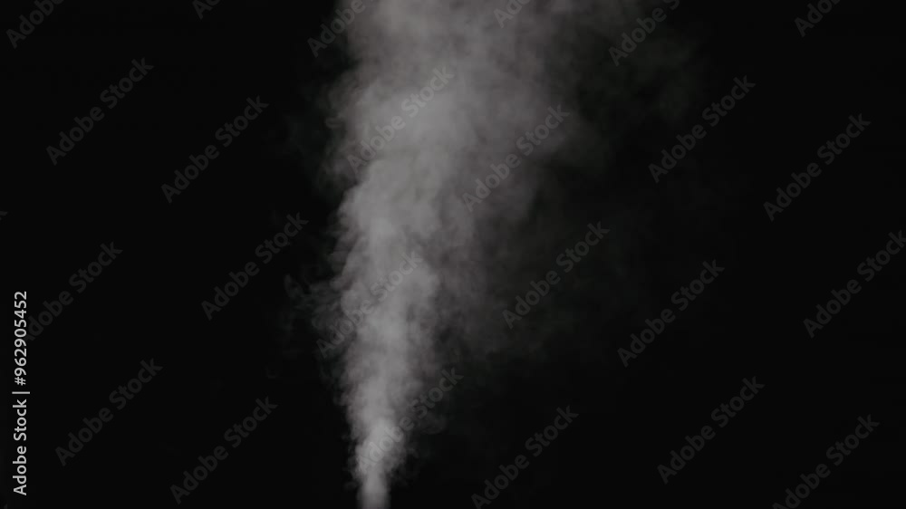 Slow motion thin water mist stream over black background