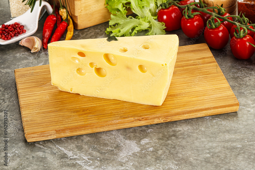 Swiss Maasdam cheese triangle over board Swiss Maasdam cheese triangle over board