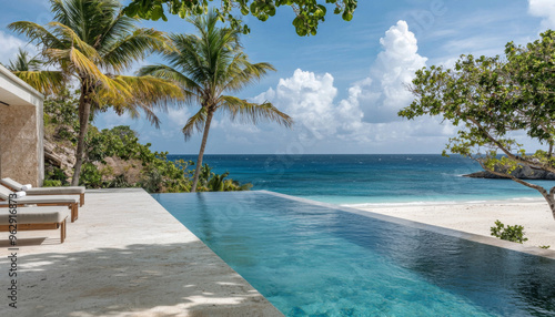 A serene infinity pool overlooking a beach and ocean, surrounded by palm trees under a bright sky.