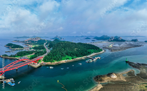 Gogunsan Islands, Gunsan-si, Jeollabuk-do, South Korea - August 16, 2020: Aerial view of Seonyu Bridge and fishing boats moored at the port of Seonyudo Island photo