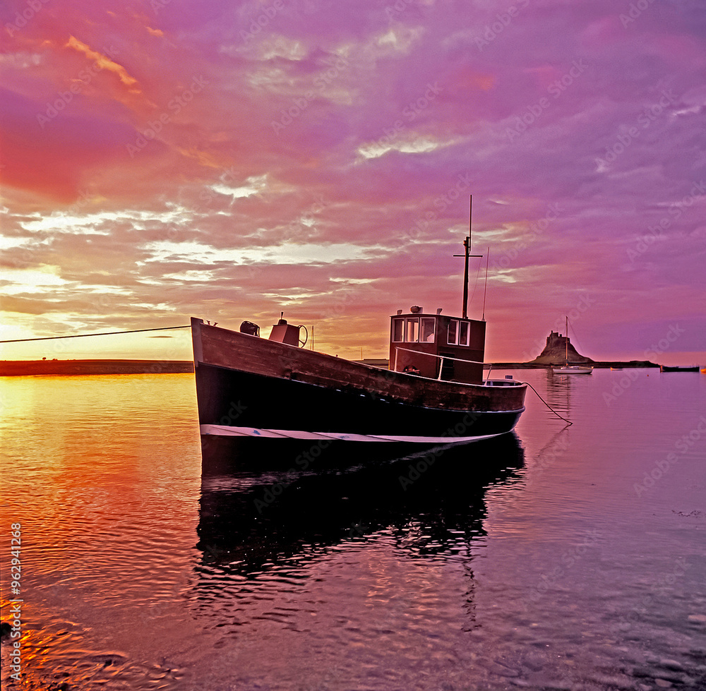 Fototapeta premium Colourful dawn at the small harbour at Lindisfarne Holy Island Northumberland