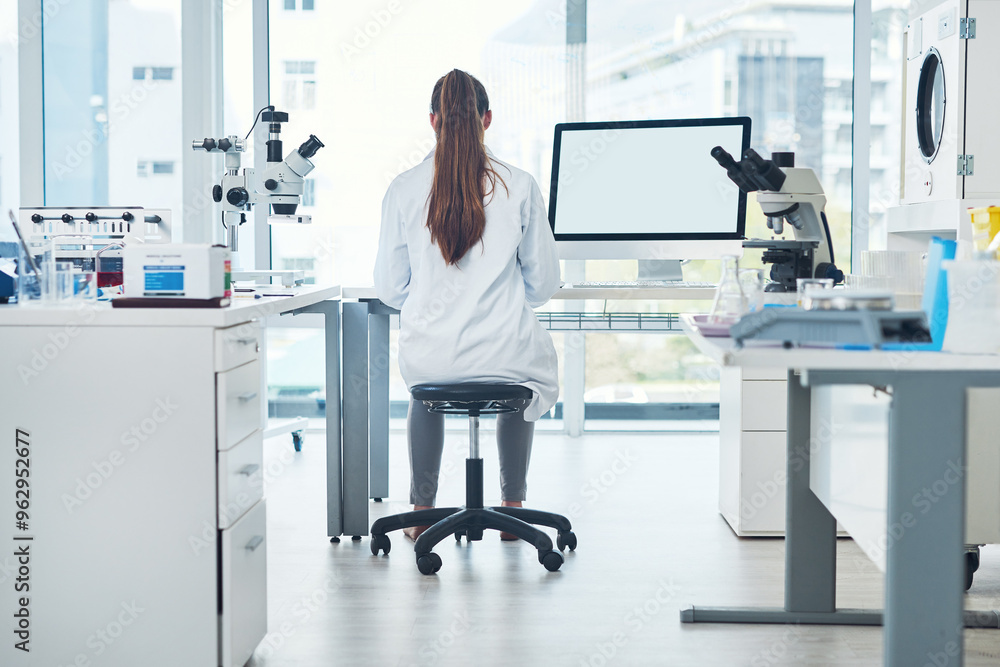Naklejka premium Science, space and woman in laboratory with computer screen for vaccine development in medical study. Biotech engineer, technician or scientist in research for pharmaceutical innovation from back