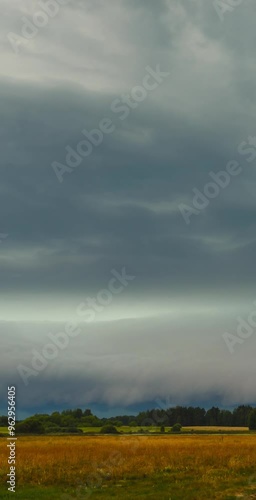 Supercell storm cloud rotating in the field. Vertical video