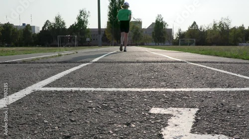 A girl in a sports uniform starts from the start in training