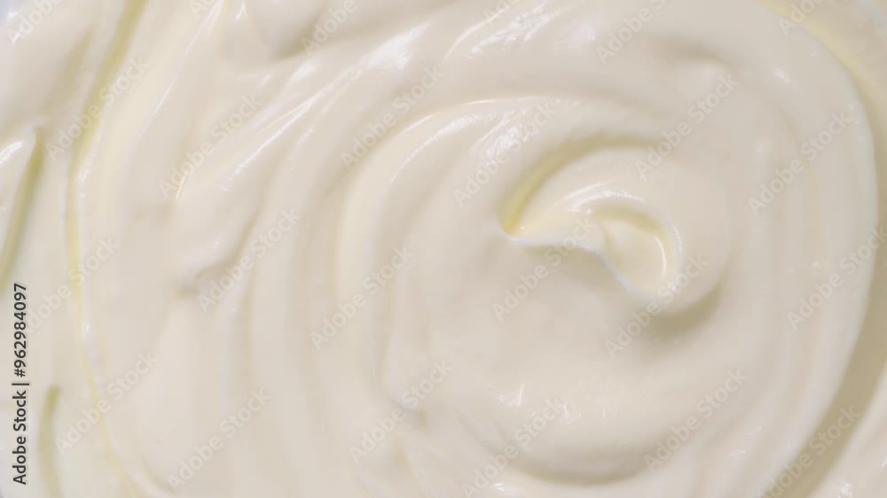 Sour cream or greek yogurt swirl, rotating texture, White cream background, close up. Dairy product. Delicious organic creamy yogurt. Milk cream. Slow motion. Top view, Macro shot Sour cream or greek yogurt swirl, rotating texture, White cream background, close up. Dairy product. Delicious organic creamy yogurt. Milk cream. Slow motion. Top view, Macro shot