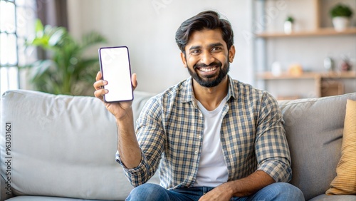  cheerful indian guy showing smartphone