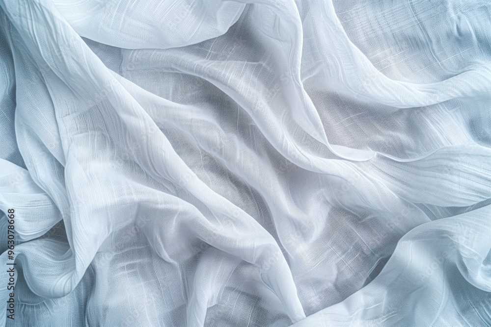Obraz premium Close-up view of white fabric with subtle texture, folded to intricate design. Fabric dominates gray background, creating serene atmosphere for fashion and lifestyle.