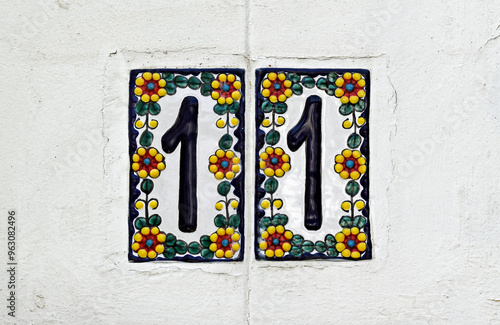 Street sign number 11 on a wite wall in the Tijuca neighborhood, Rio de Janeiro, Brazil