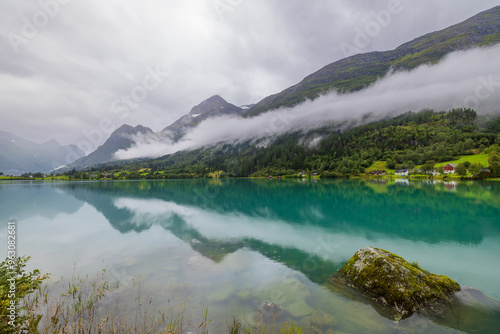 Lake Oldevatnet in the valley of Oldedalen with low hanging clouds and reflection, Norway