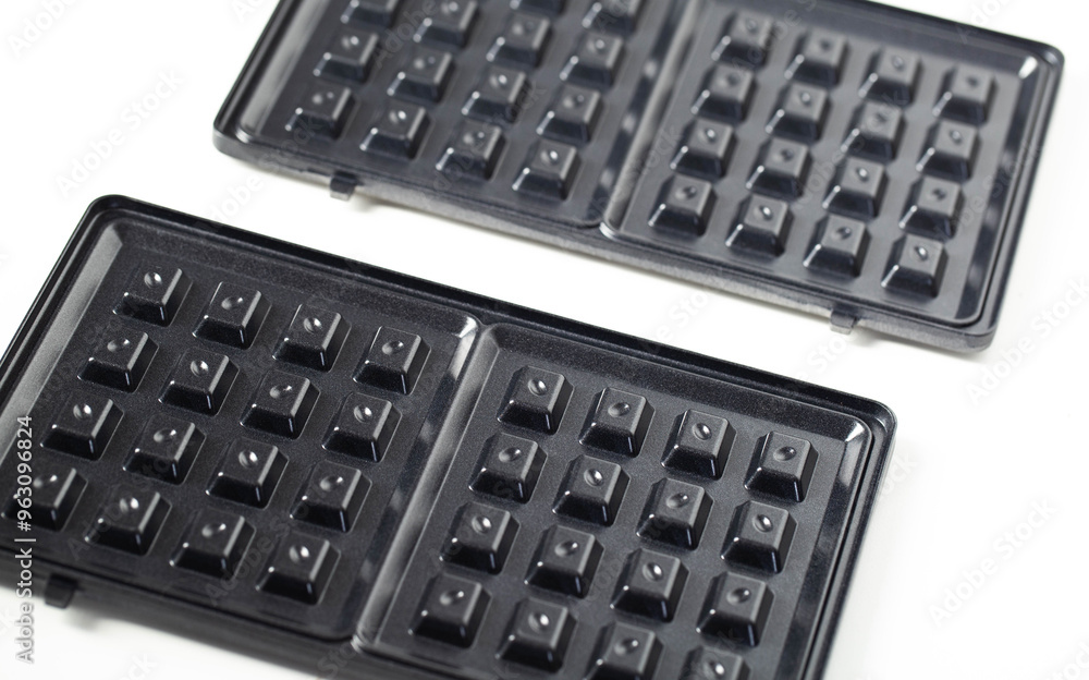 Sandwich baking pans on a white background, close-up. Sandwich baking pans on a white background, close-up.