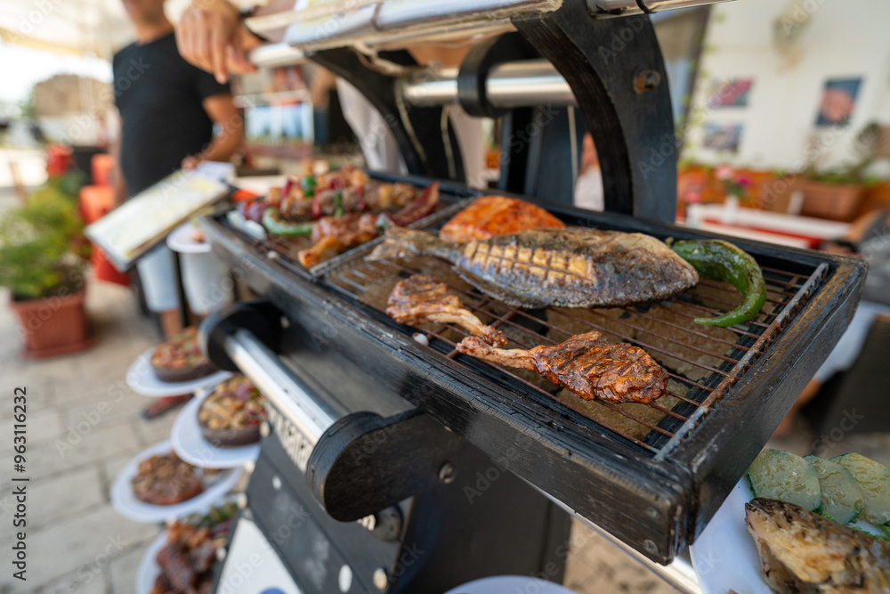 A realistic fake food display outside a restaurant featuring a T-bone steak, sides, and veggies, designed to attract customers with its detailed presentation. A clever marketing tool