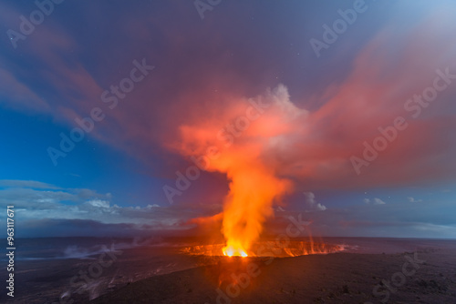 Kilauea volcano erupting during dawn shows the steamy atmosphere the hot liquid creates.