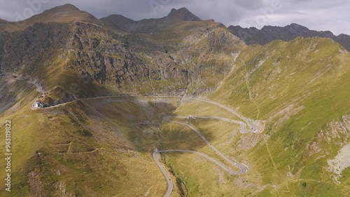 Top cinematic aerial view to the Transfagarasan famous curvy road in Romania. Aerial view of Transfagarash road in Fagarash Mountain. Romanian wild nature and landscape.  photo