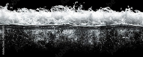 Water splashing and creating white foam against a black background. Perfect for adding a dynamic and refreshing element to your designs.