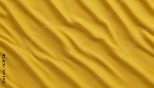 Crumpled yellow fabric with folds and creases creating an abstract textured pattern