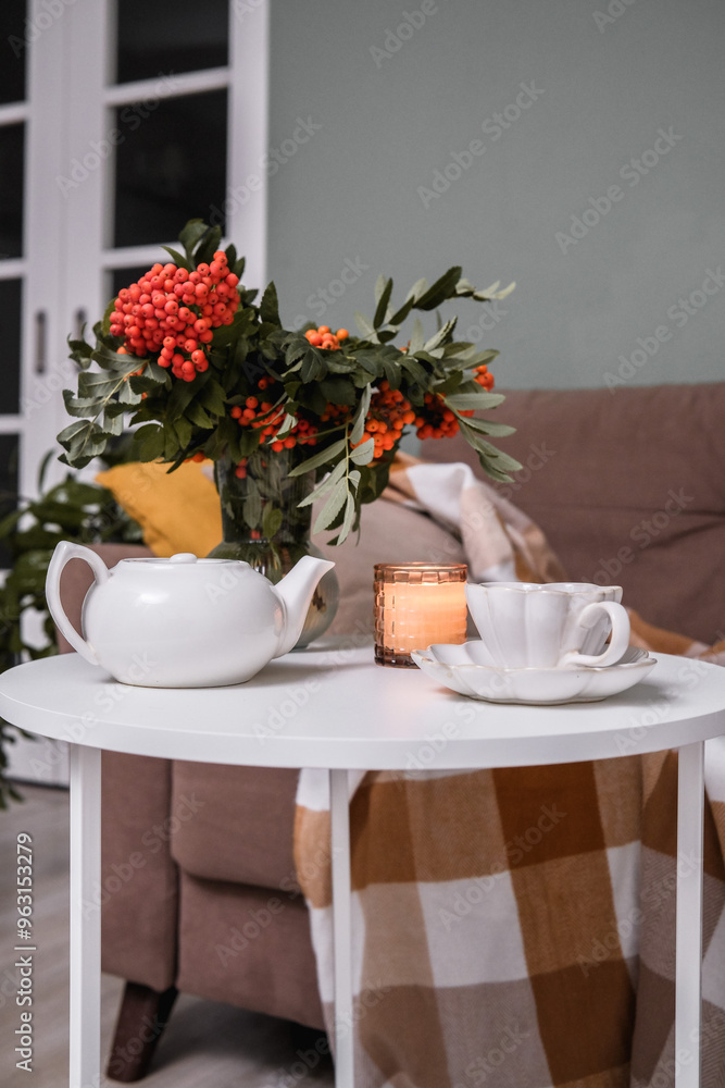 A Cozy Living Room Featuring a Soft Blanket, Lush Green Plants, and a Warm Cup of Coffee A Cozy Living Room Featuring a Soft Blanket, Lush Green Plants, and a Warm Cup of Coffee
