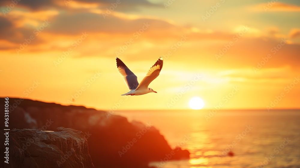 Naklejka premium 15. A lone seagull soaring over a peaceful seaside cliff at sunset