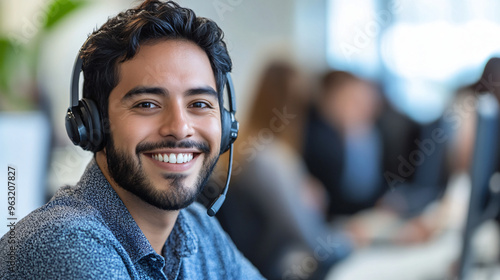 Smiling customer service rep helps clients in a busy call center office, showing teamwork in action