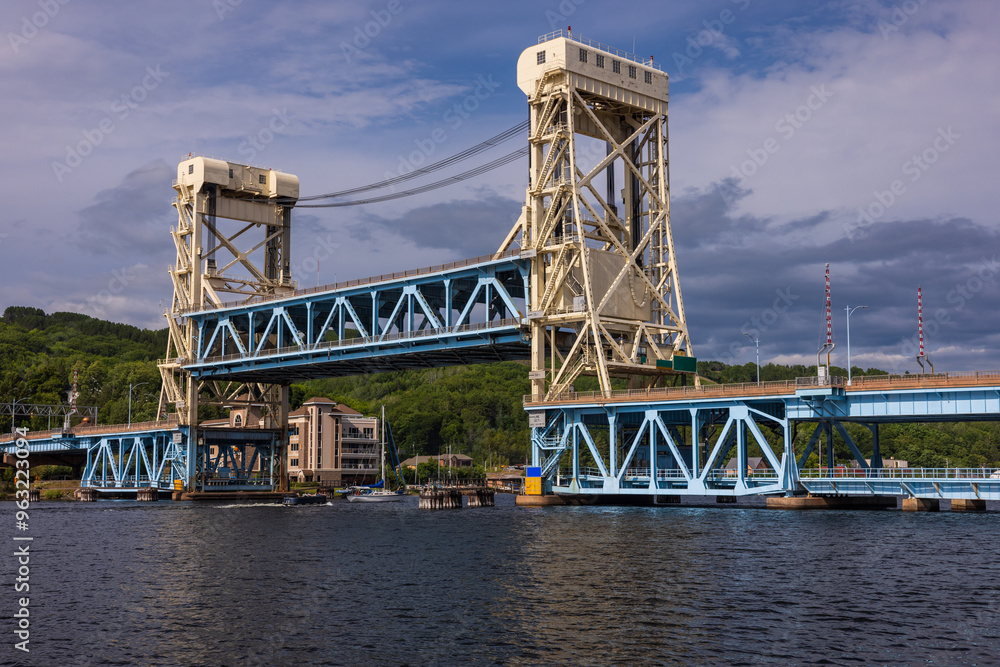A Raised Double Deck Lift Bridge with Boats Passing Underneath A Raised Double Deck Lift Bridge with Boats Passing Underneath