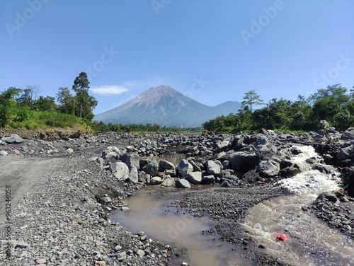 Mount Semeru during the day with a river foreground photo