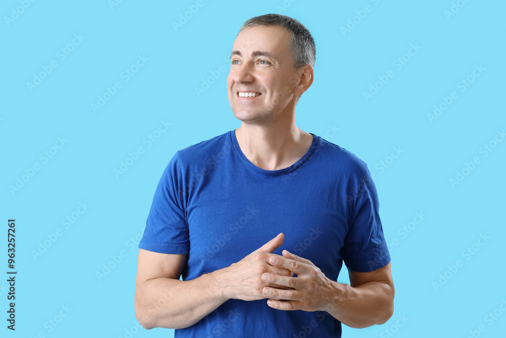Portrait of happy mature man on blue background Portrait of happy mature man on blue background